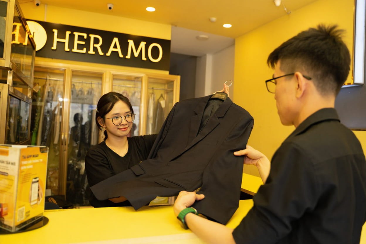 HERAMO staff delivering laundry to expat in Ho Chi Minh City